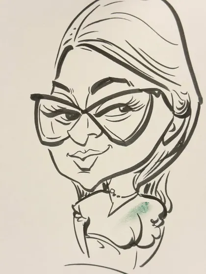 A close-up of a caricature of a woman with stylish glasses. The focus is on capturing her unique features in a fun way.