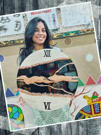 A student proudly holding her finished textured resin clock. We love seeing our students' confidence grow as they master new skills and create beautiful art.