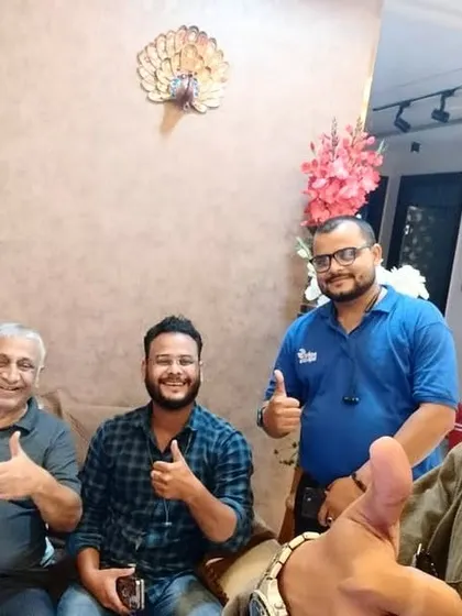 A family gives a thumbs-up with our team, excited about their new solar investment.