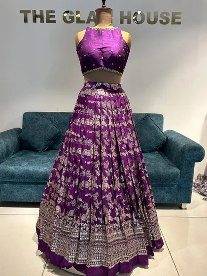 A royal purple Banarasi lehenga with a high-neck crop top. The pleats give the skirt a beautiful structure and flare.