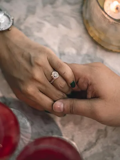 A close-up shot focusing on the engagement ring and the couple holding hands. We believe in capturing the details that symbolize the beginning of your journey together.