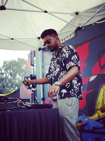 I work the music controls at Blend Bazaar's street stage, with the microphone and performance setup in front of me.