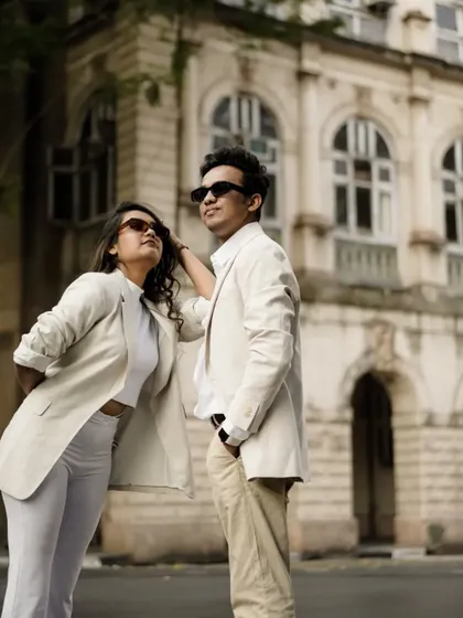 A cool, editorial-style pose against a classic Mumbai building. This shows the versatility of an urban pre-wedding shoot.