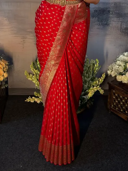 A detailed shot of the pleats on the red Kanchivaram saree. This is where the artistry lies, in creating uniform and crisp folds.