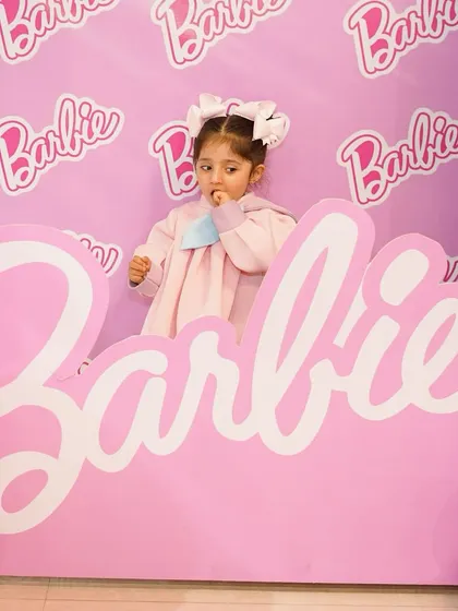 A little guest enjoying the Barbie-themed photo booth. Our interactive setups are designed to be fun for kids and provide perfect, shareable moments for parents.