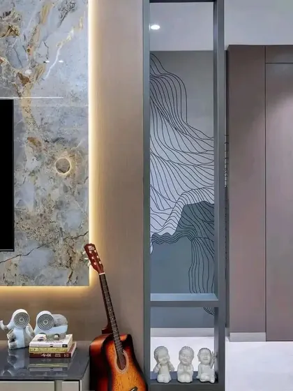A detail shot of the partition next to the TV unit, featuring a custom frosted glass design that provides separation without blocking light.