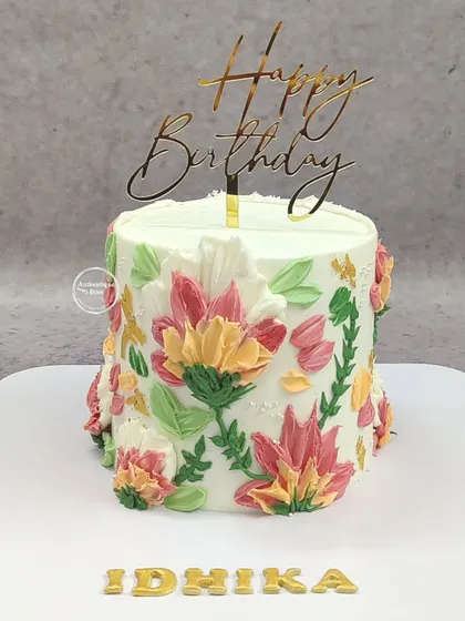 An artistic cake featuring 3D painted buttercream flowers. The vibrant colors and textured petals make this cake a true work of art.