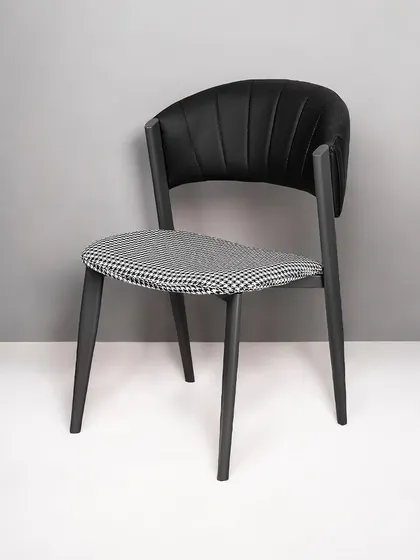 A full view of our modern dining chair with a houndstooth seat. The ergonomic backrest and padded cushion ensure comfort, while the design adds a touch of timeless style.