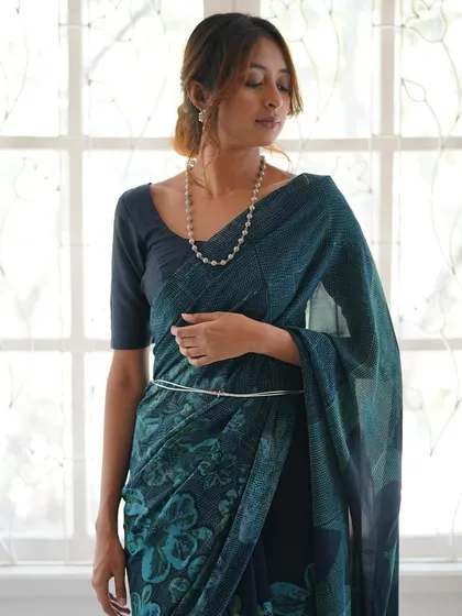 This is our hero item. The Nilā saree embodies our craft. It is a deep indigo silk georgette piece that took over 60 hours to create, combining intricate textures and custom-carved floral motifs using a specialized discharge printing technique.