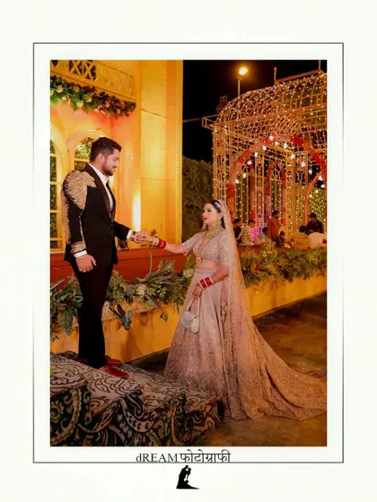 A creative pose of Tanu and Kunal at their reception venue, showcasing the beautiful architecture.