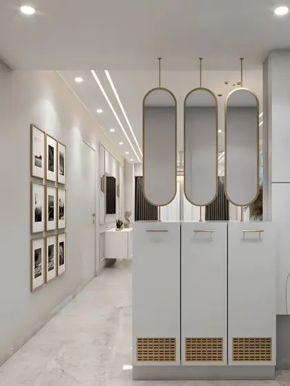 A chic and contemporary entryway with tall, minimalist shoe cabinets and artistic line drawings on the doors. The hanging oval mirrors add a touch of glamour.