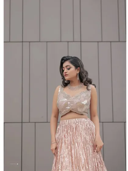 A close-up of the intricately embroidered sequin blouse and the flowing lehenga skirt.