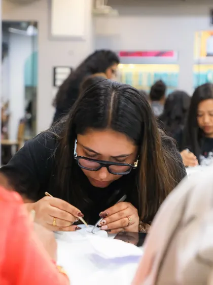 Focused and determined. Our students dive deep into practical work, learning the fine motor skills required for perfect lash application.