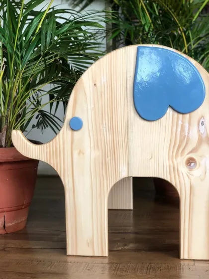 Meet my little elephant chair! Handcrafted from natural wood with a playful pop of non-toxic blue paint, this sturdy chair is designed to bring a bit of the wild into your child's room.