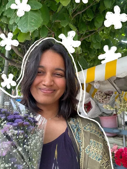 A happy selfie with a bouquet of flowers, with a simple white floral outline around my head.