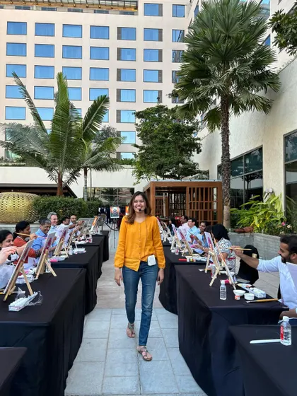 A candid shot of me walking through the aisles, checking on everyone's progress during a large outdoor workshop for a corporate client.