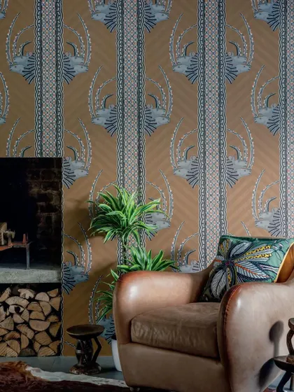 The Jabu wallpaper from Cole & Son celebrates African artistry with regal white rhinos peeking through vibrant vertical stripes. This design brings a sense of heritage and striking elegance to any space.