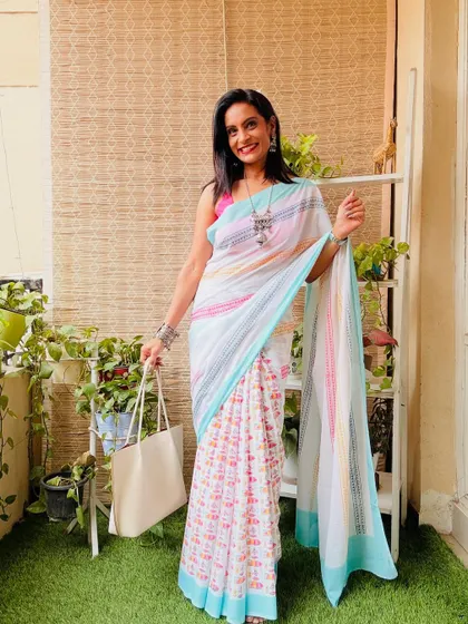 A beautiful white cotton mulmul saree with a colorful abstract print. The fabric is super soft and comfortable, perfect for summer.
