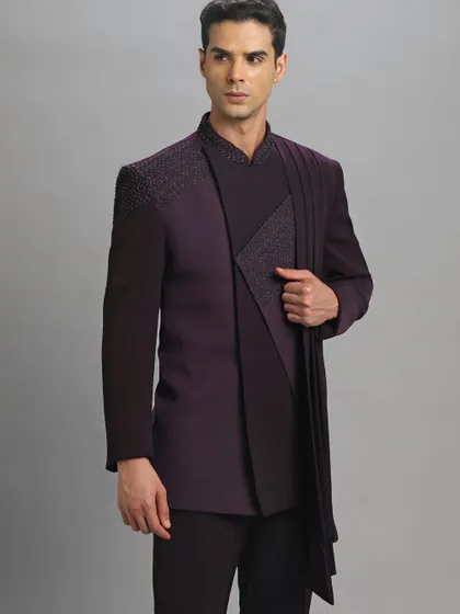 A closer look at the purple Jodhpuri with an attached dupatta. The intricate shoulder embroidery adds a touch of modern sophistication.