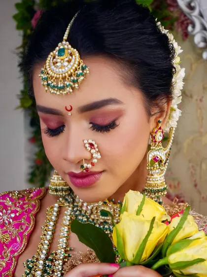 Another angle showcasing the soft, romantic hairstyle with a floral gajra, a key part of our professional hairstyling curriculum for bridal looks.