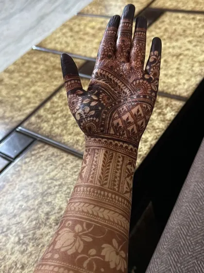 The rich, dark stain of a full-coverage Indian henna design after the paste has been removed.