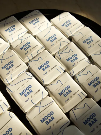 An overhead shot of the custom-wrapped "Mood Bar" soaps, highlighting the simple yet effective design for the brand collaboration.