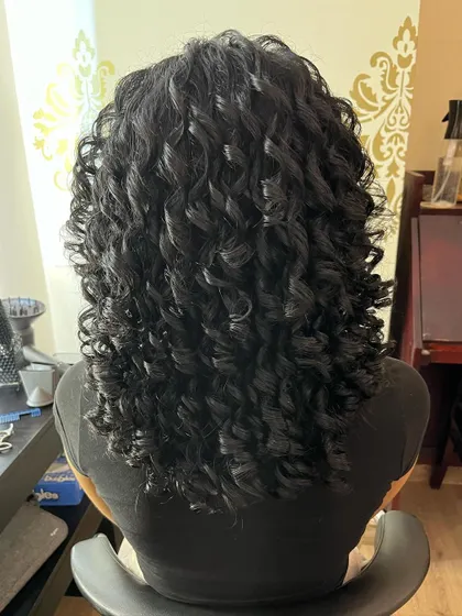 The back view of Anna's transformed curls, showing a healthy and well-defined pattern.
