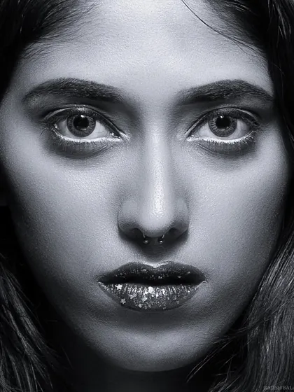 A black and white version of the intense beauty close-up, creating a dramatic and piercing portrait.