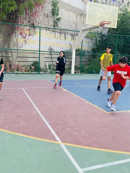 A young player dribbles the ball up the court, learning to lead the offense.