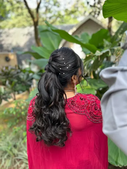 A closer look at the back of the hairstyle, with delicate pearl pins scattered through the curls for a touch of sparkle.