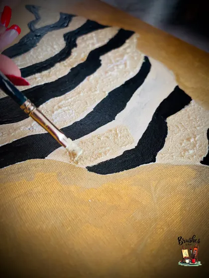 Adding the final touches. This shot captures the delicate process of applying texture to the canvas, a key element in many of the abstract pieces we create at Studio B&B.