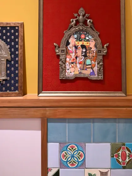 The set of two Prabhavalis displayed on a ledge, showing how they work together as a complementary pair. The contrast between the red and blue silks creates a dynamic visual story.