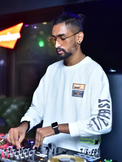 A candid shot of me focused on the mix during a Sunday special gig. I use professional-grade equipment to ensure every beat sounds crisp and powerful, delivering a premium audio experience.