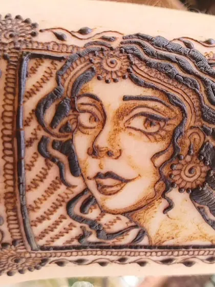 A closer look at the details of the portrait doodle, showing the fine lines in the hair and the delicate shading on the face.