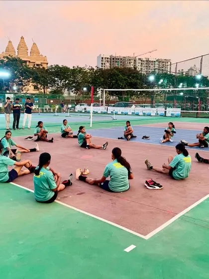 Our girls stretching in a circle on the court. This not only helps with physical recovery but also provides a moment for the team to connect after practice.