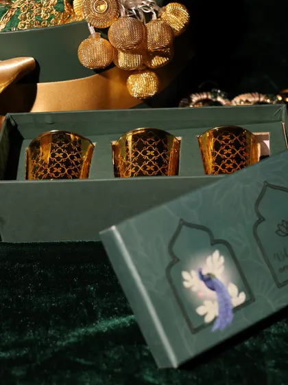 A close-up of the beautiful gold-foiled glass votives included in the DC Group corporate hampers, perfect for adding a festive glow.