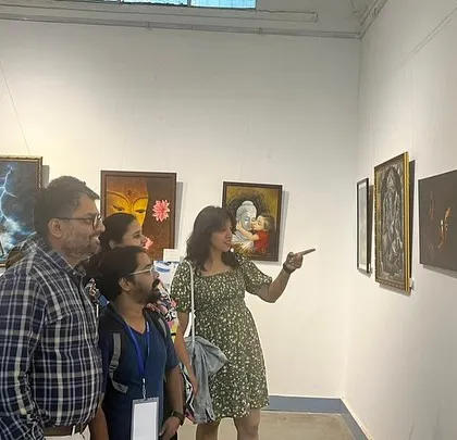 An art enthusiast pointing out details in one of my paintings.