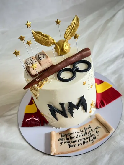 Happiness can be found, even in the darkest of times, if one only remembers to turn on the light. A smaller, detailed Harry Potter cake with a hand-painted scroll, wand, and golden snitch.