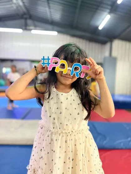 A sweet pose with her party glasses. Even our quietest students love to get in on the fun of our celebrations.