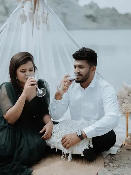 A close-up of a couple enjoying their styled picnic, toasting with wine. These detail shots add to the story of their pre-wedding session.