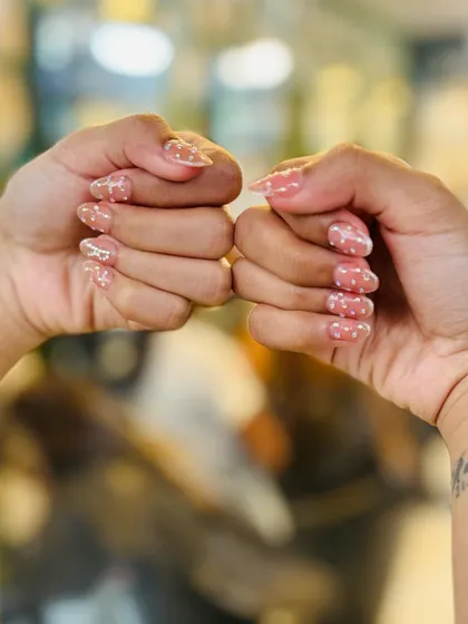 A close-up of the sheer polka dot nails, demonstrating how this subtle art can elevate a natural manicure.