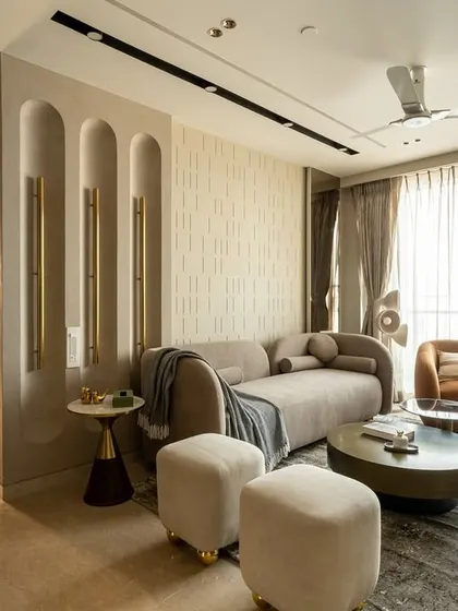 Neutral, but never boring. This living room blends calm tones with bold furniture accents for the perfect pop. The seamless textures and material mix bring depth and quiet drama, from the HDHMR paneling to the bespoke wall light.