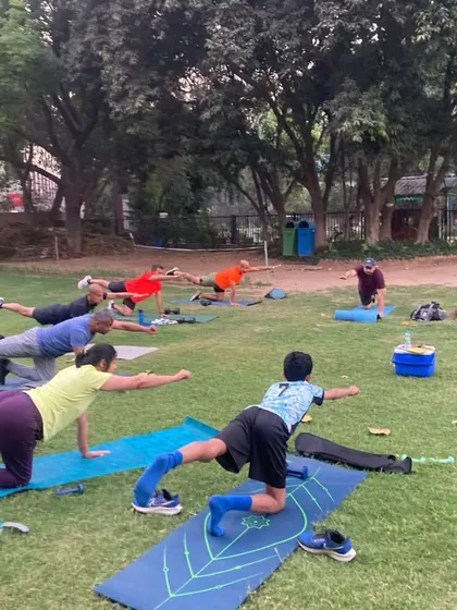 From winter PBs to summer sweat. Training never stops. Here, the tribe works on bird-dog poses to improve core stability and balance, essential for an efficient running form.