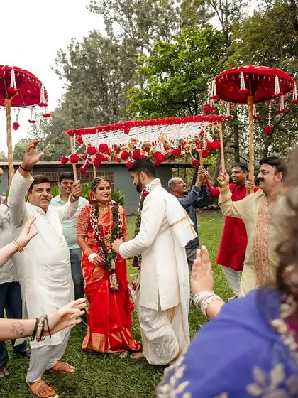 The bride and groom's grand entrance, surrounded by family and friends in a joyous procession.
