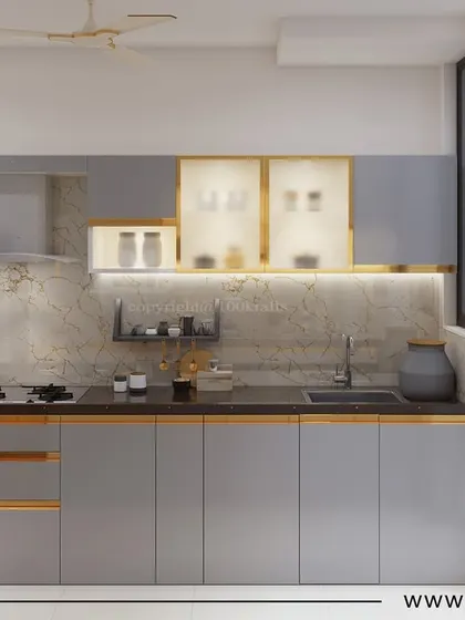 The kitchen from our 'Konark Oasis' project. The cool grey cabinets with gold-toned inlay are paired with a marble backsplash and countertop, creating a look of modern sophistication.