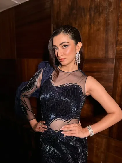 A confident pose showing off the full cocktail look. The makeup is designed to be flawless and long-lasting, ensuring she looks perfect all night.