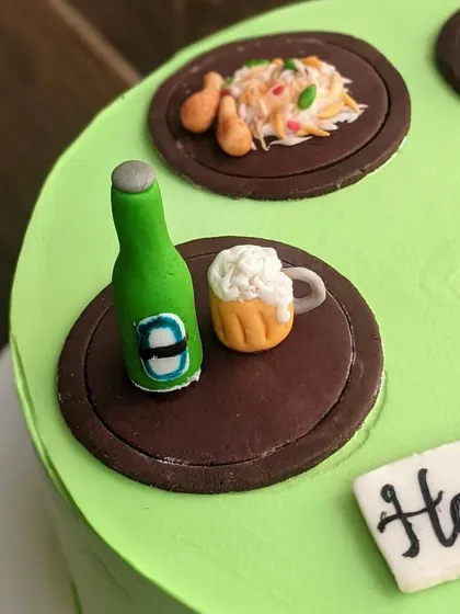 A mini beer bottle and a frothy mug, all made from fondant. These tiny toppers are perfect for adding a fun, personal touch to any celebration cake.