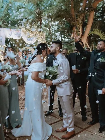 A joyous moment as the couple is showered with white petals by their friends and family. This is the perfect ending to a beautiful and elegant ceremony.