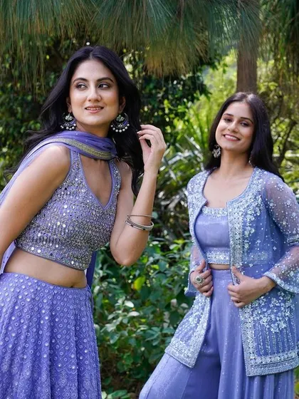 A candid shot of two models in lavender ethnic wear, set against a natural, green backdrop. Their relaxed poses and smiles give the image an authentic feel, perfect for a lifestyle-oriented fashion brand.