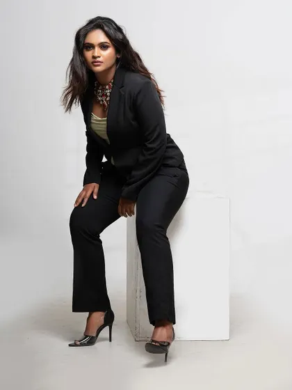 The power suit is a versatile piece. Here, it's styled for a strong, confident look that is perfect for a professional woman.